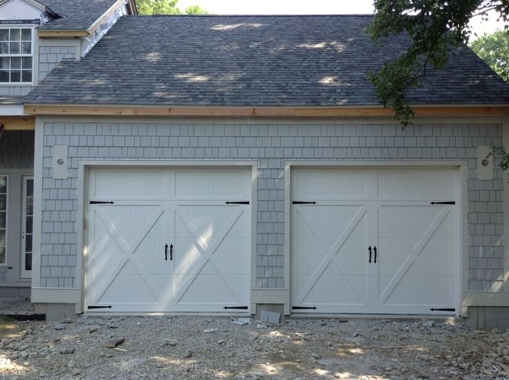 Carriage-style white garage door installation on a Florida home