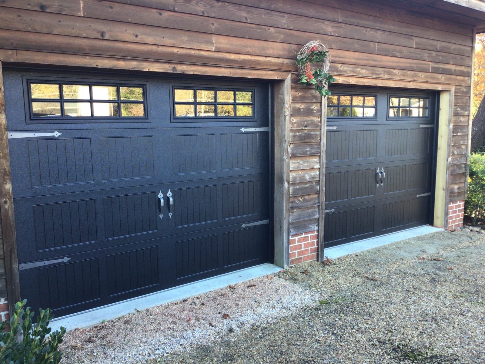 Two-car modern black garage doors on a coastal Florida home